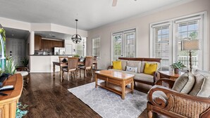 A spacious living area with a dining table, sofa, and a ceiling fan. - Reunion Resort condo near Disney w/ balcony (Kissimmee)