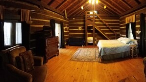 A log cabin room with a wooden floor, a bunk bed, a dresser, a chair, and a window with curtains. - Beautiful views from cabin in private nature reserve, 10 min to Pigeon Forge (Pigeon Forge)