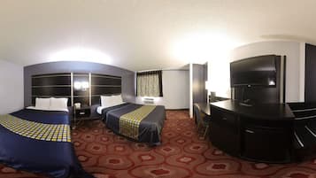 A hotel room with two beds, a desk, a television, and a minibar.
