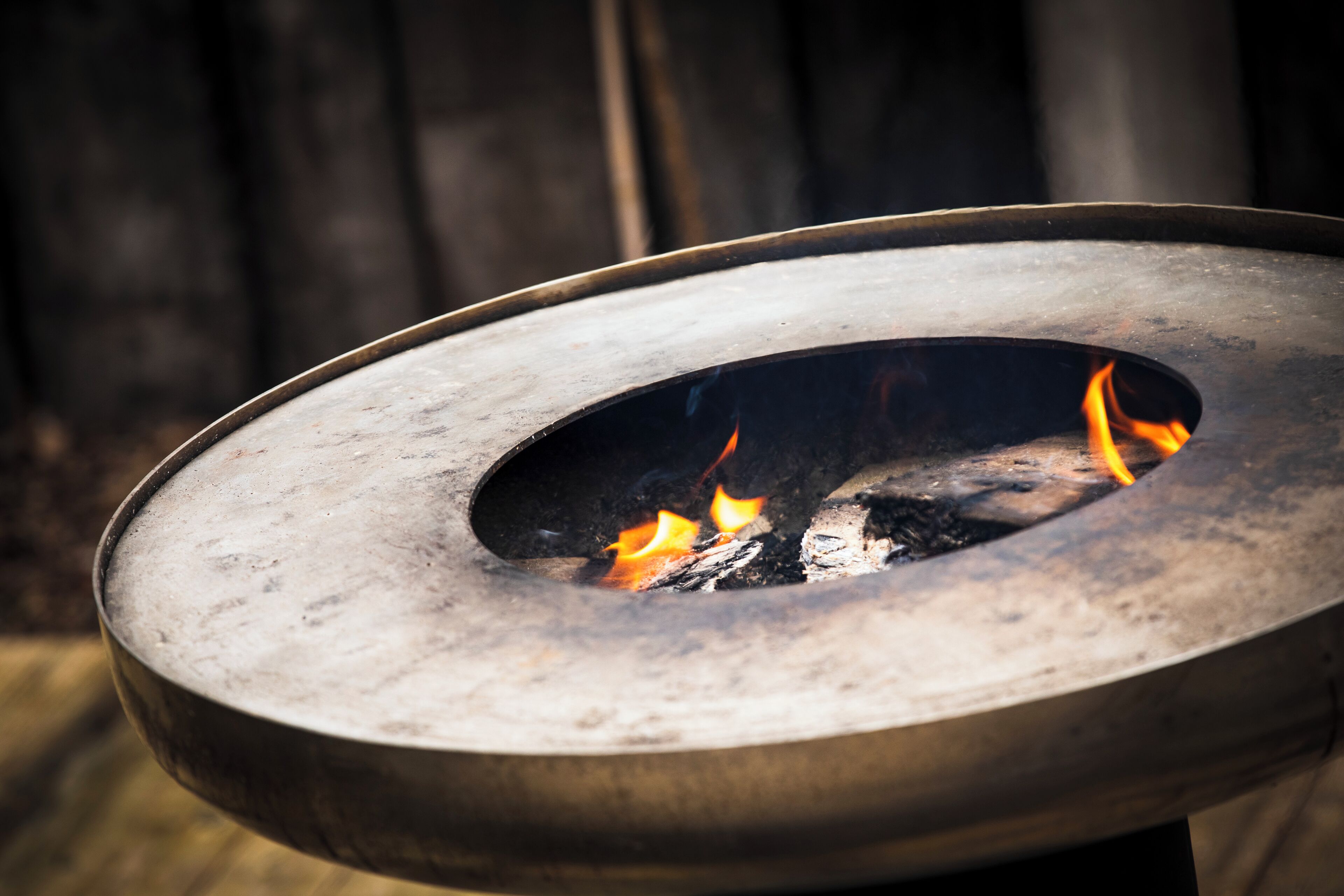 A metal fire pit with flames.