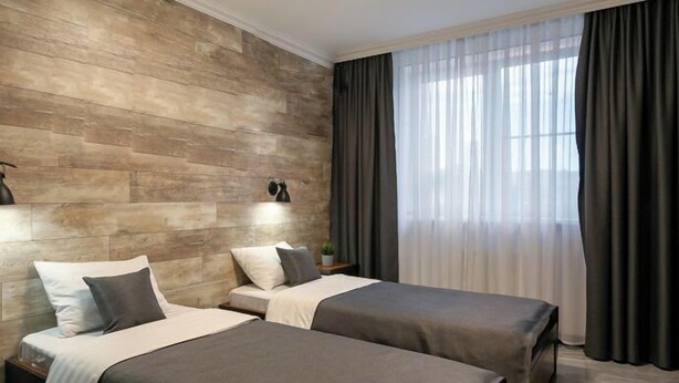 A modern hotel room with two single beds, a wooden accent wall, a large window with curtains, and a ceiling light. - EVN Boutique Hotel  (Yerevan)