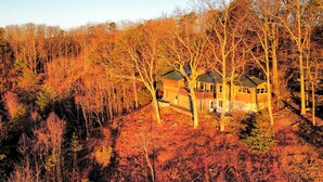 Ein Haus, umgeben von Bäumen im Herbst.