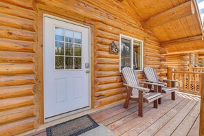 A log cabin with a white door, two Adirondack chairs on the porch, and a wooden railing. - Soldotna Fisherman's Cabin ~ 6 Mi to Kenai River (Soldotna)