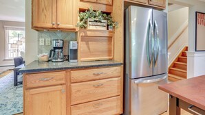 A kitchen with wooden cabinets, a stainless steel refrigerator, and a coffee maker. - Charming Highland Falls Home < 2 Mi to West Point! (Highland Falls)