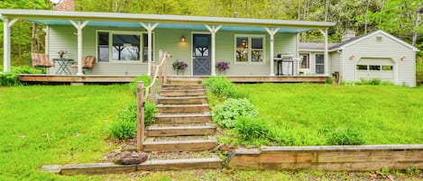 A house with a porch, a front door, and a small garage.