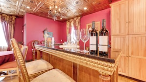 A bar area with a wooden counter, bar stools, and wine bottles. - Saloon-style Prosser Loft in WA Wine Country! (Prosser)