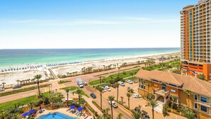 A hotel with a view of the beach, a swimming pool, and a parking area. - Tower 3-0904 Stunning Sunset Views! (Pensacola Beach)