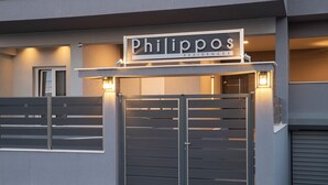 A gated entrance to a building labeled "Philipps Residences" with a modern design and two illuminated signs above the gate. - Philippos Residences (Dio-Olympos)