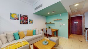 A modern living room with a sofa, coffee table, and artwork on the wall.