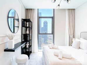 Relax in a stylish room with a large bed, city view, and modern amenities.