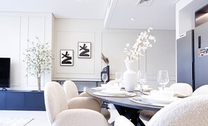 Enjoy meals in this stylish dining area with a round table, flat-screen TV, and kitchenette.