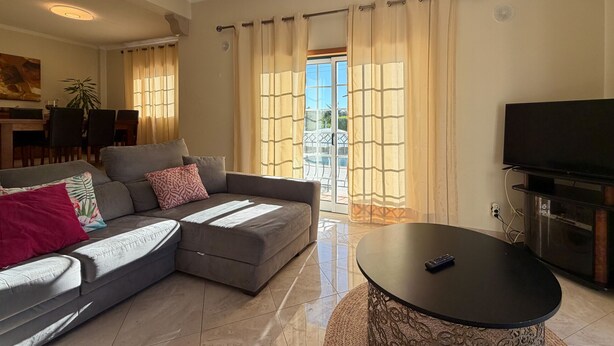 A living room with a sofa, a coffee table, and a TV. - Villa Sao Miguel (Albufeira)