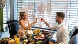 A dining table set with various dishes, drinks, and a decorative centerpiece. - SPA VILLA Beauty und Wellness Resort (Wingerode)