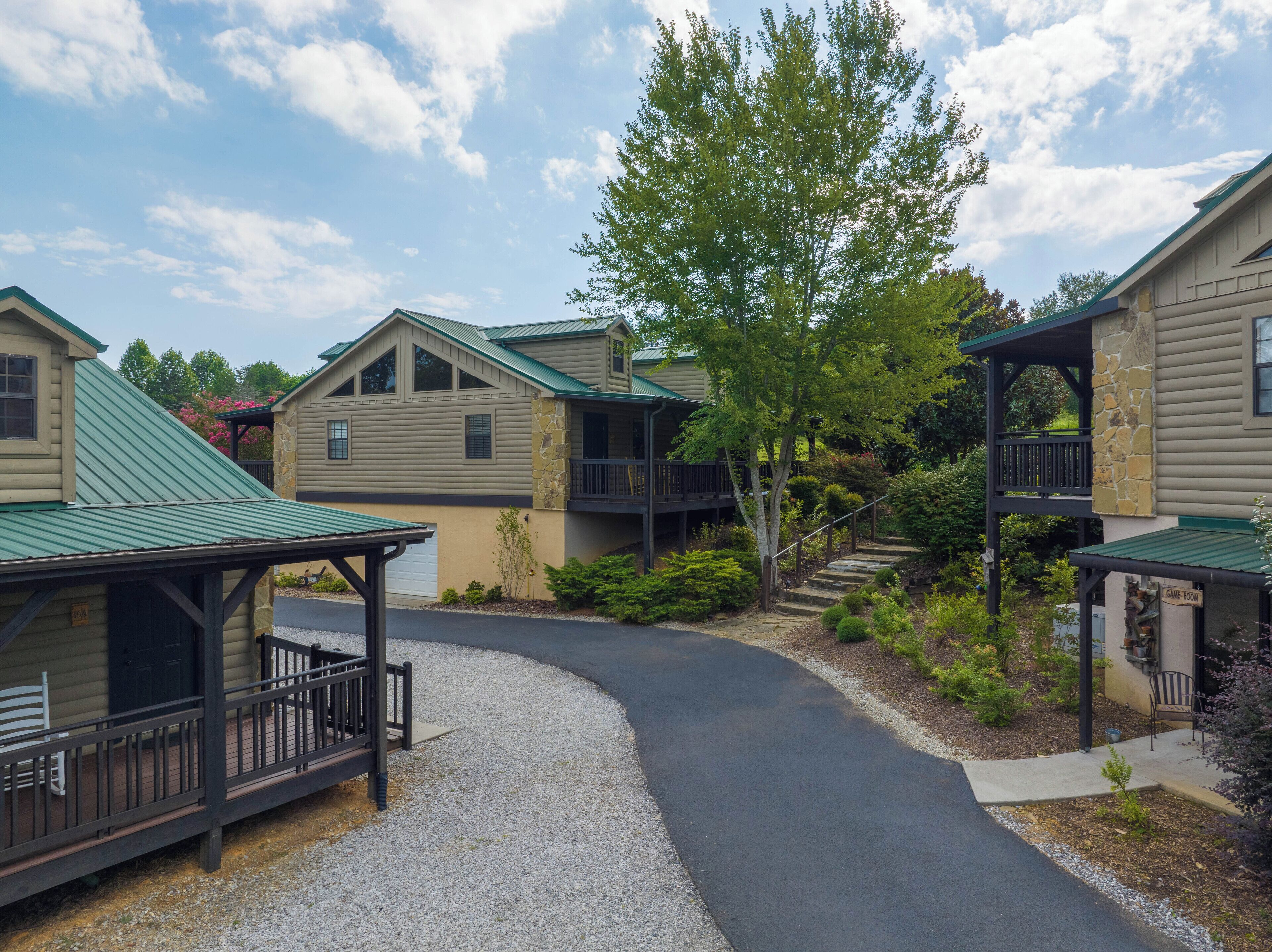 A residential area with multiple houses, a covered walkway, and a gravel path.