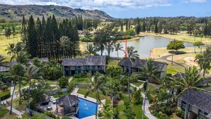 A resort with multiple buildings, a swimming pool, and a golf course.