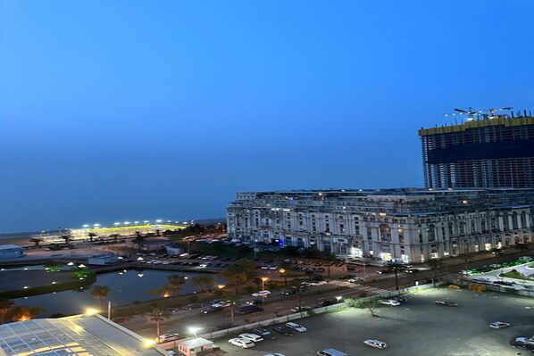 A large, historic building with a central courtyard and surrounding parking.