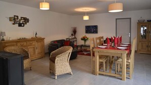 A living room with a dining area, wooden furniture, and pendant lighting. - La Maison d'Alphonse 4 people (SAINT LEGER DU MALZIEU)