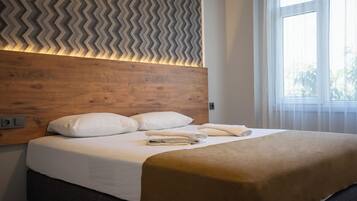 Family Suite, Partial Sea View | Minibar, desk, laptop workspace, free WiFi