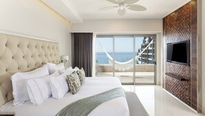 A hotel room with a large bed, a television, and a view of the ocean. - Dream Cabo Residence with Ocean Views (Cabo San Lucas)