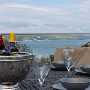 Savor a meal with a serene coastal view.