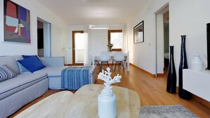 A modern living room with a sofa, coffee table, and decorative vase.