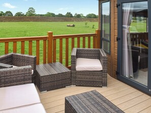 Terrace/patio - A lovely bright lodge next to a field on a great site for people of all ages. (Stowmarket)