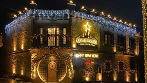 A building with festive decorations, a sign reading 'ASHAB-KEFE,' and a 'HAPPY NEW YEAR' message. - Ashab-ı Kehf Cappadocia House (Nevsehir)