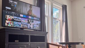 A television displaying a streaming service interface with various movie options. - Stone Willow Inn (St. Mary's)