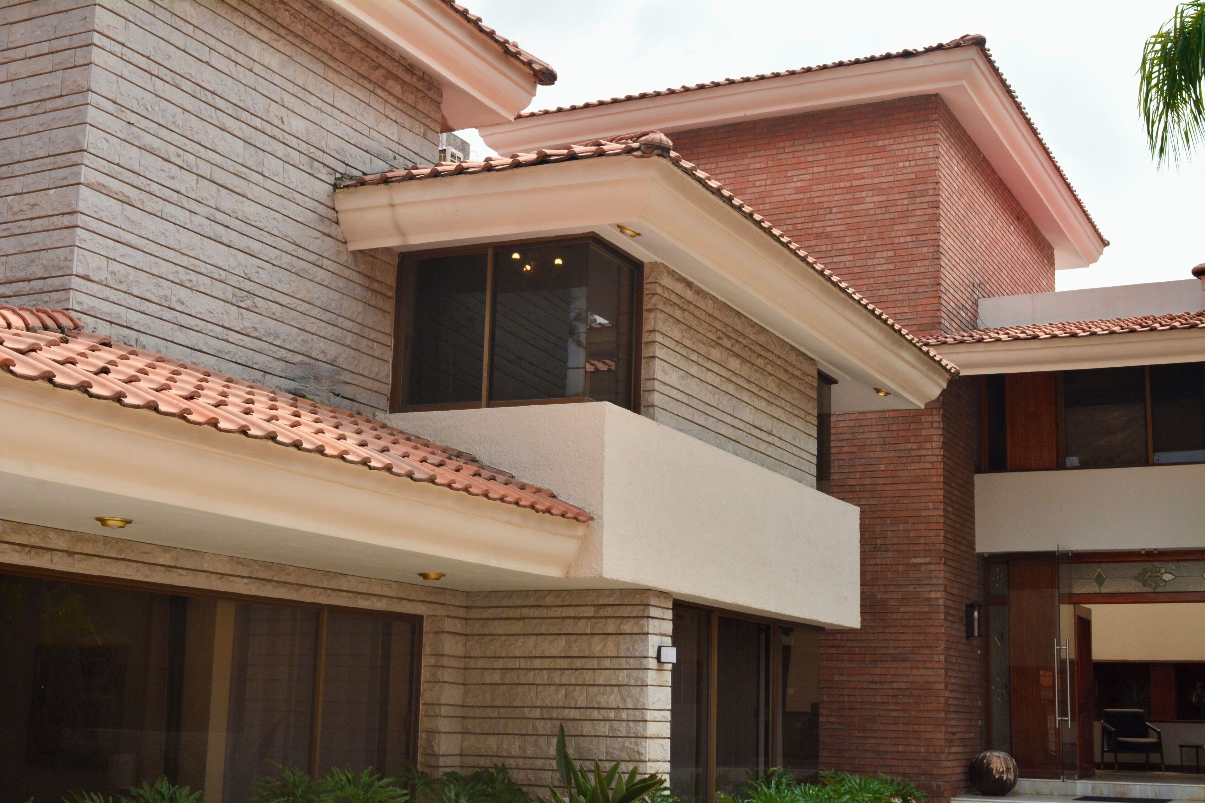 A two-story building with a flat roof, large windows, and a brick facade.