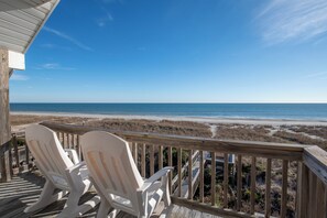 Relax in Adirondack chairs on this elevated deck overlooking the sandy beach and ocean.
