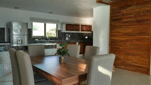Eine moderne Küche mit Marmorarbeitsplatte, Edelstahlgeräten und Holzausbau.