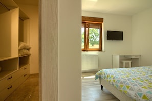 A bedroom with a bed, a wardrobe, a radiator, a window, and a television. - Villa Markulin Comfortable holiday residence (Pula)