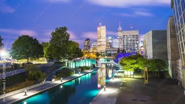 A nighttime cityscape with a river, illuminated buildings, and a bridge. - Home w/ Garden Oasis Walk to Lucas Oil Traeger Grill EV Charger (Indianapolis)