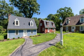 A residential area with three houses, each with distinct siding colors and gabled roofs. - Galena Settlement Getaway (Galena)
