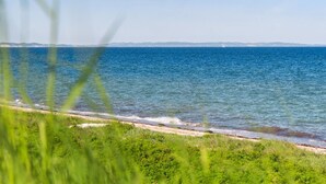 A coastal view with a sandy beach and ocean. - "Jolanta" - 20m from the sea by Interhome (Malling)