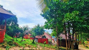 A rural village with traditional houses, a dirt path, and lush greenery. - Europe Enchanted Bungalow Koh Rong (Koh Rong)