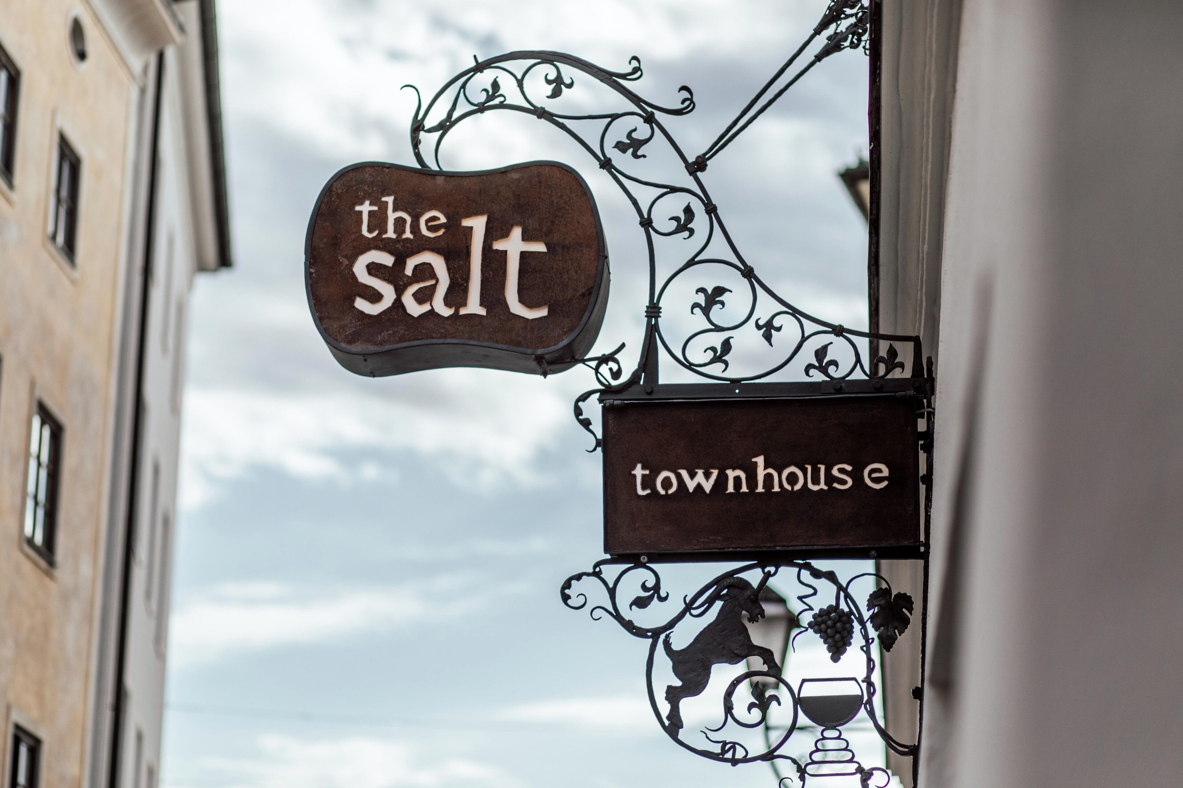 A sign for 'The Salt Townhouse' with a decorative metalwork design.