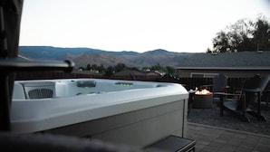 A hot tub with a view of mountains in the background.