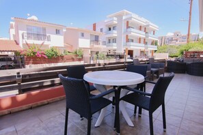 Relax in this outdoor seating area with a round table and four comfortable chairs.