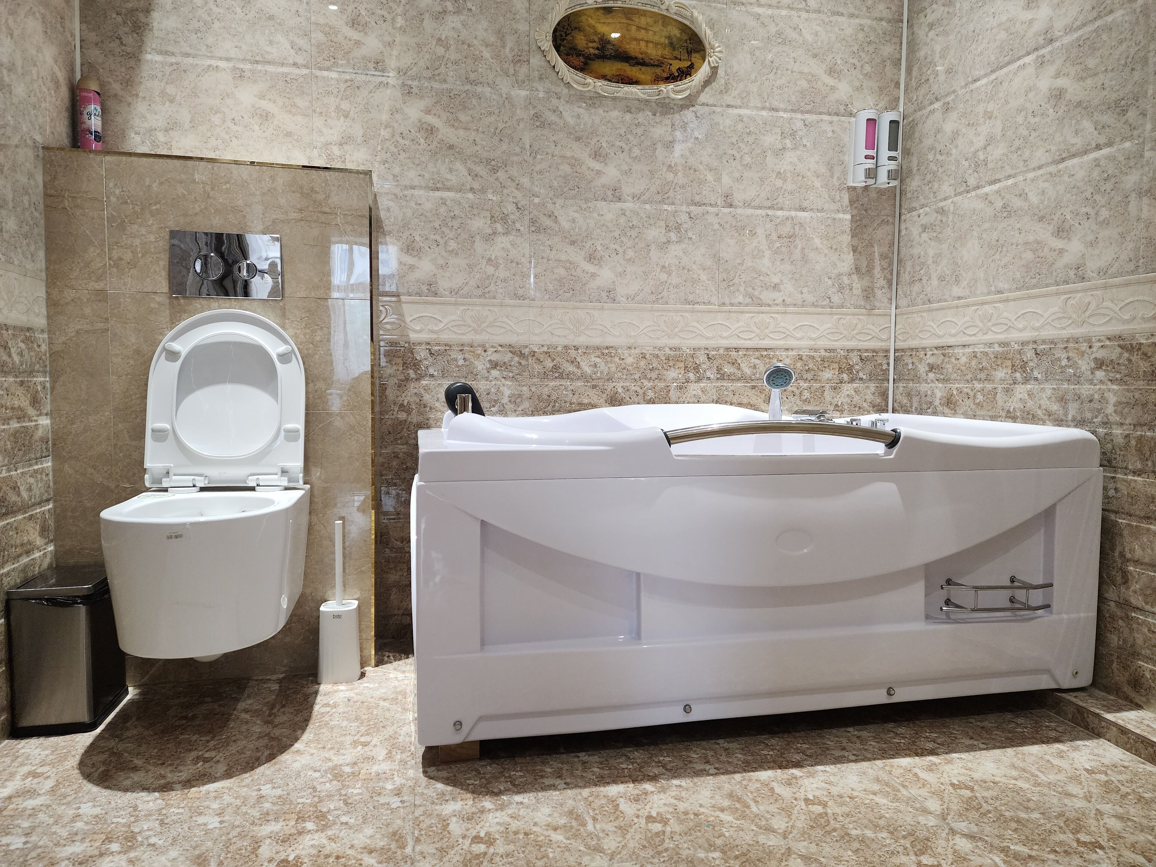 A bathroom with a toilet, bidet, and a bathtub.