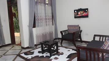 Deluxe Double Room, Balcony | Living area | 48-inch LED TV with cable channels