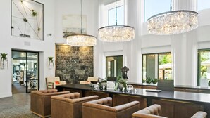 A spacious kitchen with a central island, pendant lighting, and a view of the outdoors. - TWO CozySuites at Kierland Commons  (Scottsdale)