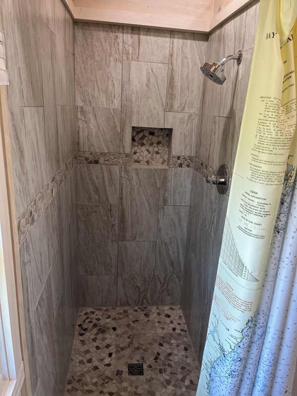 A shower area with a tiled floor and a showerhead. - Ocean front home directly on Dyers Bay! (Steuben)