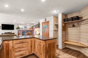 A modern kitchen with wooden cabinets, a granite countertop, and a built-in oven. - Cozy Condo, Wood Burning Fireplace, Central Area (Breckenridge)