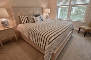 A bedroom with a bed, nightstands, a chair, and a window. - Coastal Club Community w Resort-Style Amenities* 6 (Lewes)