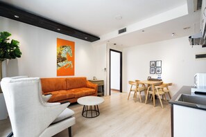 Deluxe Apartment, 2 Bedrooms, Kitchen, City View | Living area | 24-inch LCD TV with cable channels - The Lancaster - ANGIA Hospitality (Ho Chi Minh City)