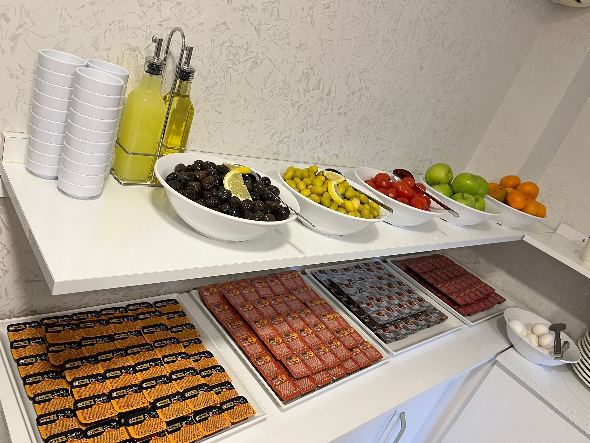 Una mesa de buffet con diversos alimentos y salsas.
