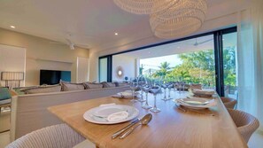 Enjoy a meal in style with a long dining table set for a special occasion.