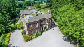 A large, two-story brick building with a symmetrical facade, a central entrance, and a spacious driveway. - Chelsea Parkfields  (Ross-on-Wye)
