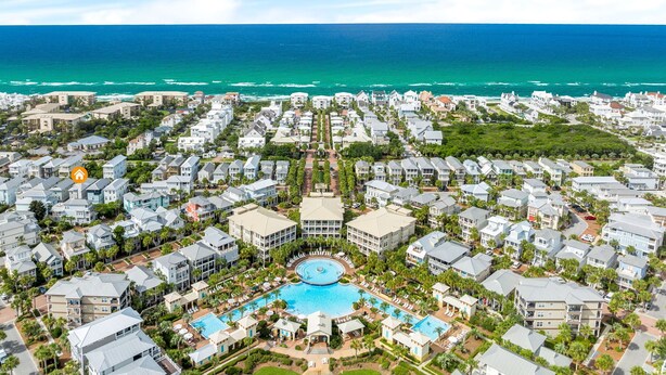 An aerial view of a coastal resort with multiple buildings, a central swimming pool, and a view of the ocean. - Sailfish Lookout, Private Beach Access (Panama City Beach)